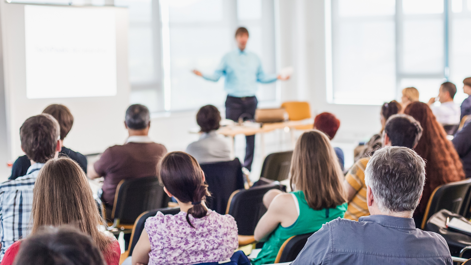Speaker addressing audience in a seminar room