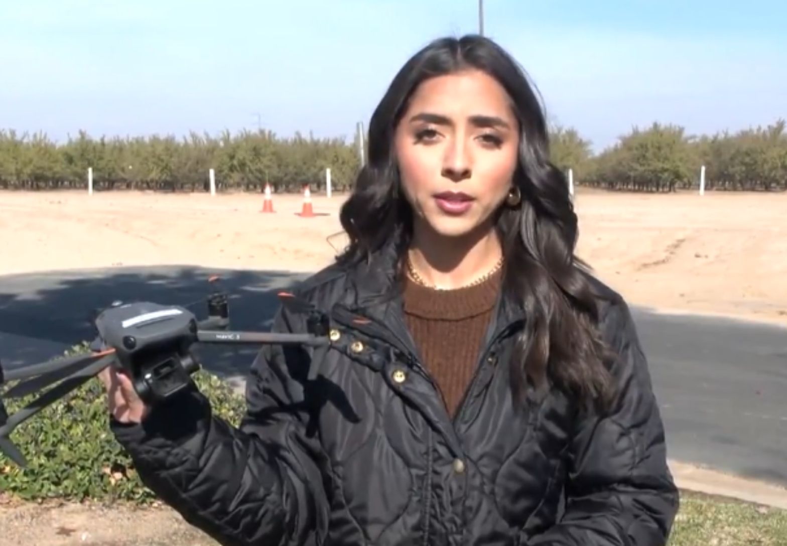 Reporter holding drone