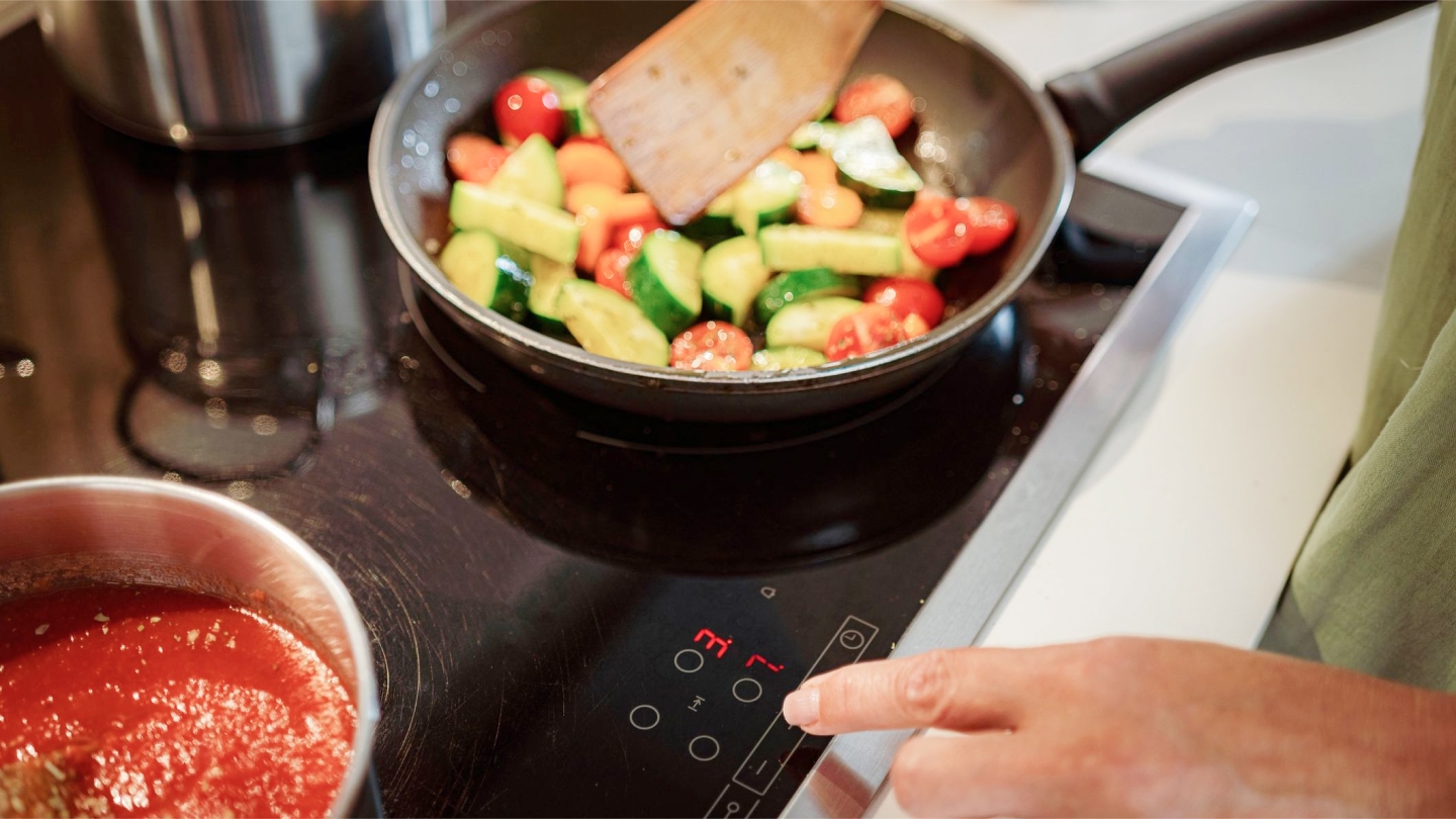 Skillet with veggies on electric range